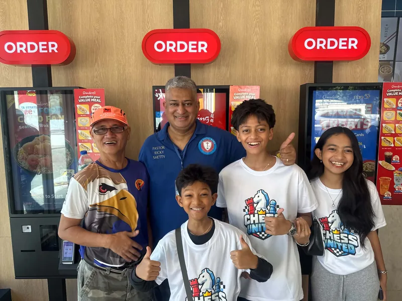 Chess United members and young players in club shirts at Chowking.